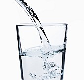 Water being poured into a glass (close up)