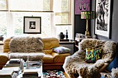 Sheepskin rugs on easy chair and sofa in artistic living room