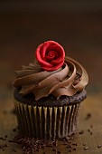 A chocolate cupcake with a rose decoration for Valentine's Day