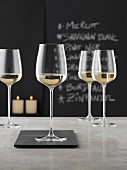 Glasses of white wine on a grey counter in a wine bar