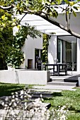 Garden path to the modern house with terrace and pergola