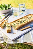 Savoury tart with peas and cheese, sliced