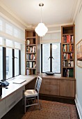 Custom fitted shelves and desk in small study