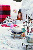 Teapots on set and decorated table outside in wintry atmosphere