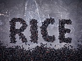 Black rice spelling the word 'Rice'