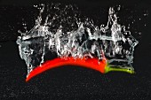 A chilli pepper falling into water