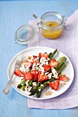 Grilled asparagus and strawberry salad with feta cheese and orange glaze
