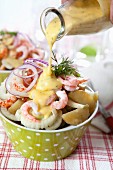 Potato salad with fennel, crustaceans, red onions and mustard dressing