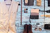 Clothing, accessories and utensils hung on pastel blue wall