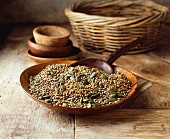 Pumpkin seeds, flaxseed and hemp seeds in a wooden bowl on a wooden table