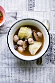 Thai soup with white cabbage, shiitake mushrooms and meat dumplings