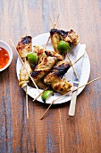 Grilled chicken wing kebabs with limes (Thailand)
