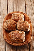 Seeded rolls in a wooden bowl