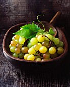 Green grapes in a vintage wooden bowl