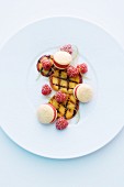 Grilled peach with ice cream macaroons and raspberries