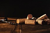 An arrangement of corks and a corkscrew