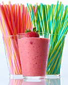 A strawberry smoothie and colourful straws