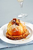 A baked apple served on a slice of panettone