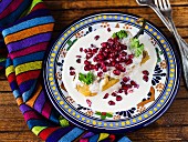 Chiles en Nogada (stuffed Poblano chilli with a walnut sauce and pomegranate seeds, Mexico)