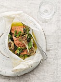 Salmon with olives and artichokes in parchment paper