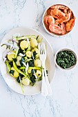 Boiled potatoes with kale and chlorella tapenade and prawns
