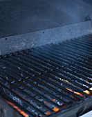A cooking grid over a smoking charcoal grill