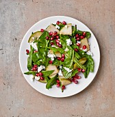 Dandelion salad with pear, pomegranate seeds and cream cheese