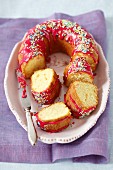 Vanilla cake with beetroot glaze and sugar sprinkles