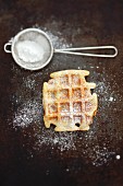A waffle with icing sugar