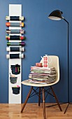 Magazine rack made from board and denim on blue wall