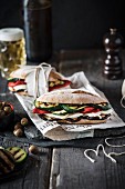 Grilled vegetable and mozzarella sandwiches served with beer