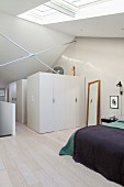 Wall brace and white cupboards in attic bedroom