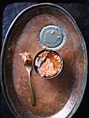 Tinned salmon on a copper plate