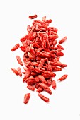 Dried goji berries on a white surface