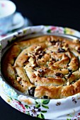 Poppyseed cake in a baking dish with a floral scarf