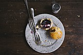 Breakfast bun with blueberry jam on a plate with a fork