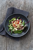 Barley salad with feta cheese and vegetables on a bed of lettuce