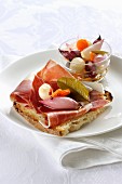 Grilled bread topped with Tuscan raw ham and pickled vegetables
