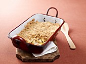 Apple crumble with oranges in a baking dish