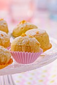 Steamed orange cakes with glaze and icing sugar