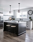 Country house kitchen with island under pendant lights