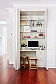 Open folding sliding door in front of a built-in desk and shelf in an elegant living environment