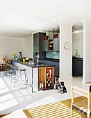 Elegant fitted kitchen with free-standing counter and open-fronted wooden shelves