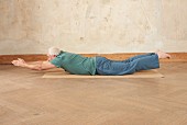 Boat (yoga), on the mat: lie on front, raise arms and legs