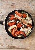 Fried lobster tails with garlic in a pan