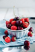 Strawberries and cherries in a metal bowl