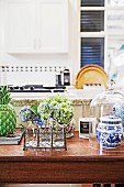 Wooden table with floral decoration, glass hood and porcelain box