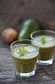 Green smoothies made with kiwi, avocado and parsley