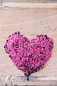 Heart made from pink and black rice (top view)