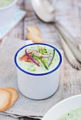 Cold courgette and cucumber soup in an enamel mug